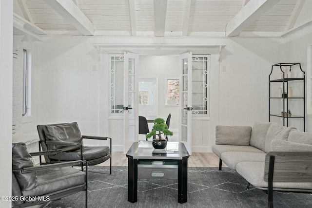 living area featuring french doors, wooden ceiling, wood finished floors, and beam ceiling