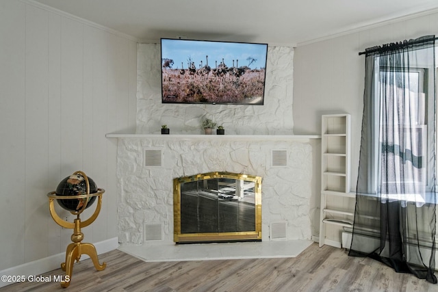 room details with visible vents, a stone fireplace, and wood finished floors