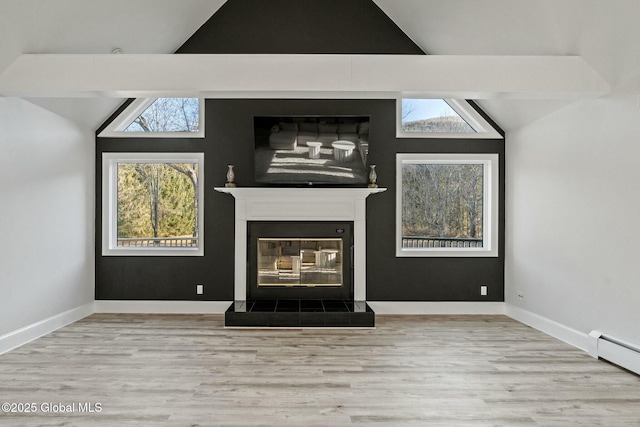 unfurnished living room with vaulted ceiling, wood finished floors, baseboard heating, and a glass covered fireplace