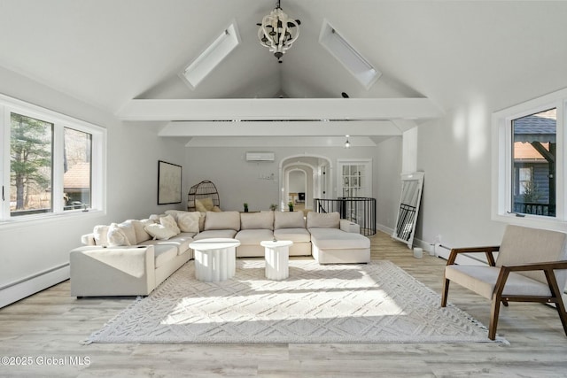 living area with arched walkways, a chandelier, light wood-style flooring, a baseboard heating unit, and high vaulted ceiling