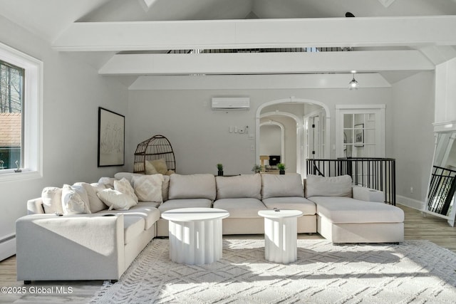 living room with vaulted ceiling with beams, light wood-style floors, arched walkways, and a wall mounted AC