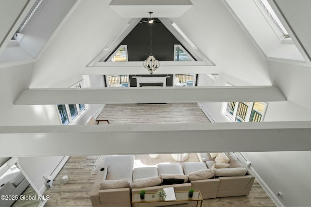 interior space with plenty of natural light, high vaulted ceiling, and wood finished floors