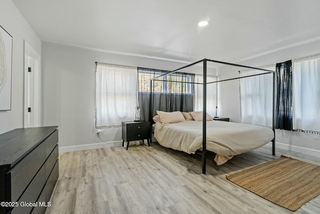 bedroom with light wood-style floors and baseboards