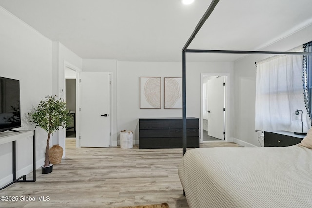 bedroom with baseboards and wood finished floors