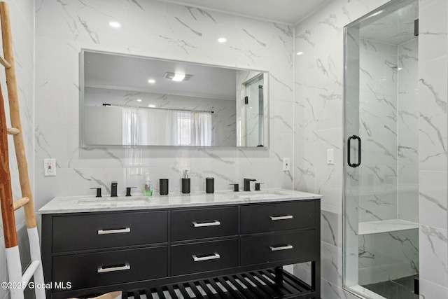 full bath with double vanity, tasteful backsplash, a marble finish shower, and a sink