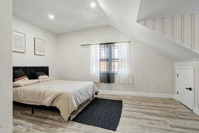 bedroom featuring vaulted ceiling, recessed lighting, wood finished floors, and baseboards