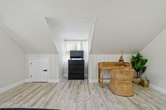 additional living space featuring lofted ceiling, baseboards, and wood finished floors