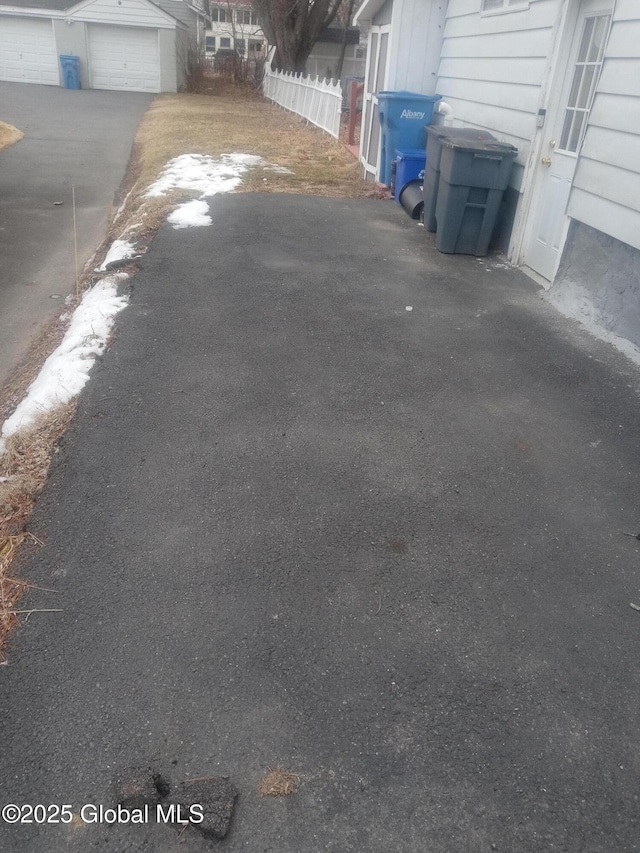 exterior space featuring driveway and fence