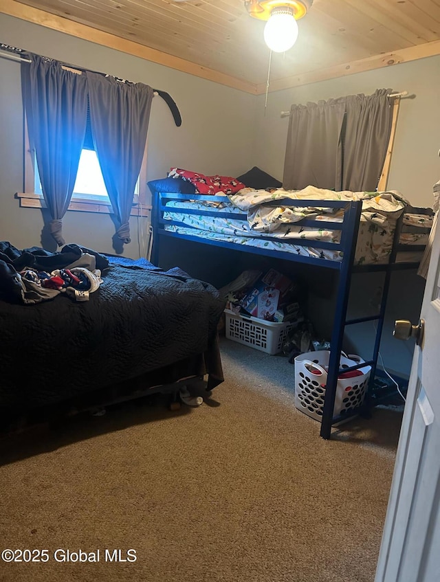 carpeted bedroom with wood ceiling