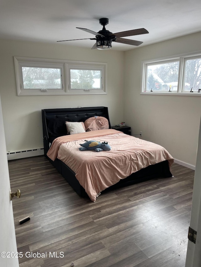 bedroom featuring baseboards, a baseboard radiator, a ceiling fan, and wood finished floors