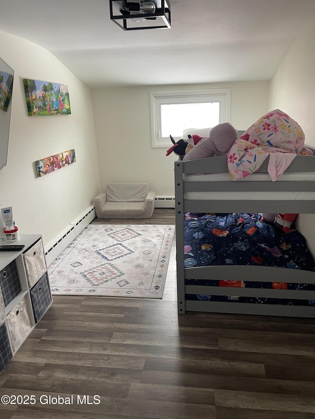 bedroom featuring a baseboard heating unit and wood finished floors