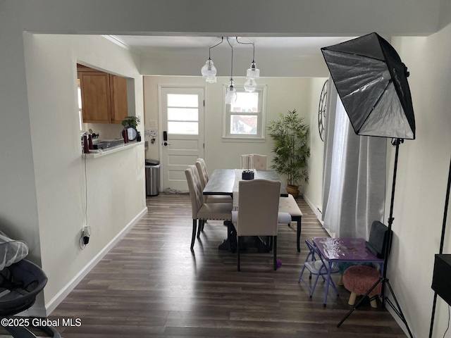 dining area with dark wood-style floors and baseboards