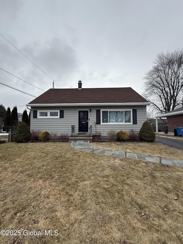 single story home with a front lawn and a chimney