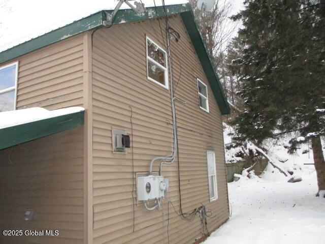 view of snowy exterior featuring metal roof