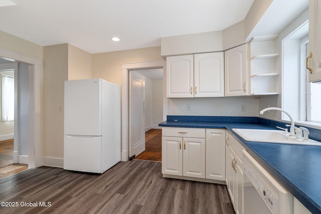 kitchen with dark wood finished floors, open shelves, white cabinets, a sink, and white appliances