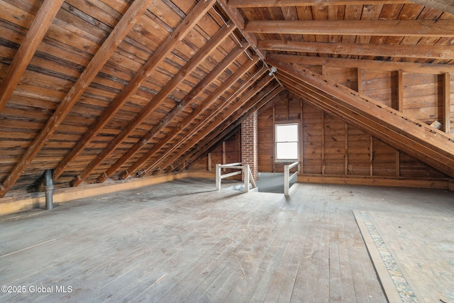 unfinished attic with an upstairs landing