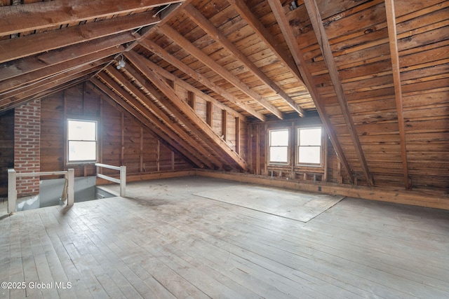 unfinished attic with a wealth of natural light and an upstairs landing