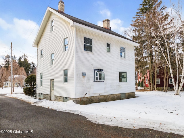 view of side of property with a chimney