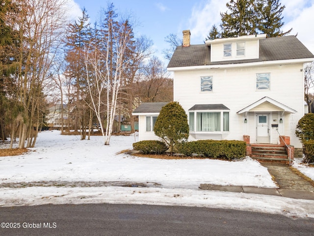 american foursquare style home with a chimney