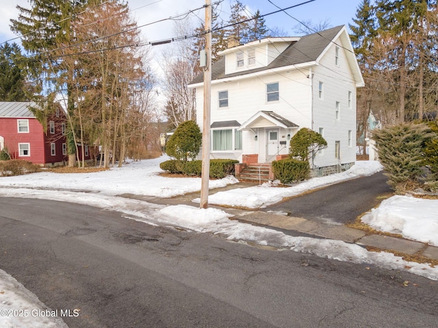 american foursquare style home featuring a chimney