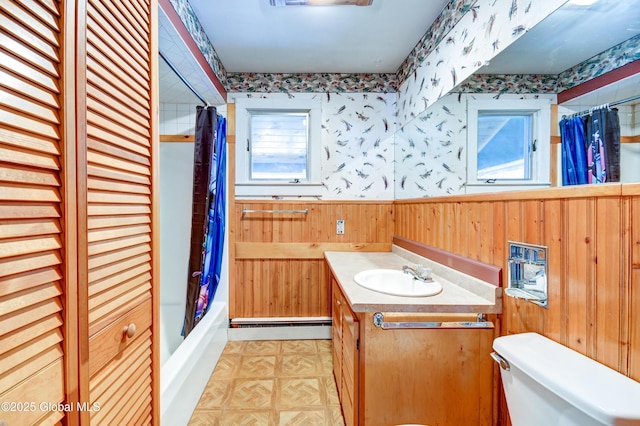 244 Kingsboro Ave, Gloversville, NY 12078 - full bath featuring a baseboard heating unit, wooden walls, wallpapered walls, wainscoting, and toilet