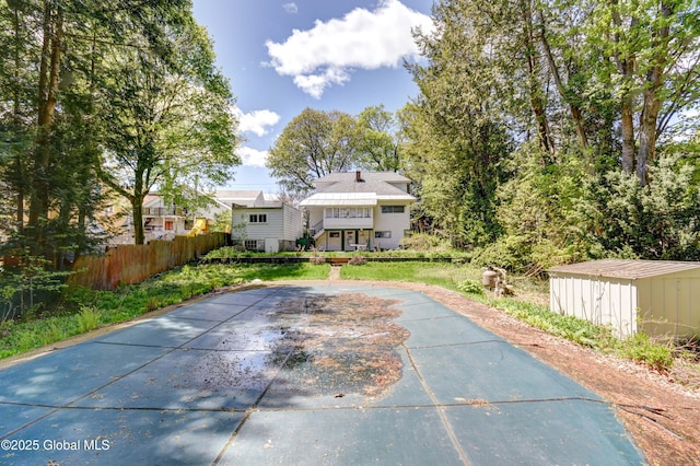 244 Kingsboro Ave, Gloversville, NY 12078 - back of house with fence, a storage shed, and an outdoor structure