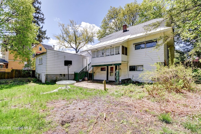 244 Kingsboro Ave, Gloversville, NY 12078 - back of house featuring a chimney, stairs, and a sunroom
