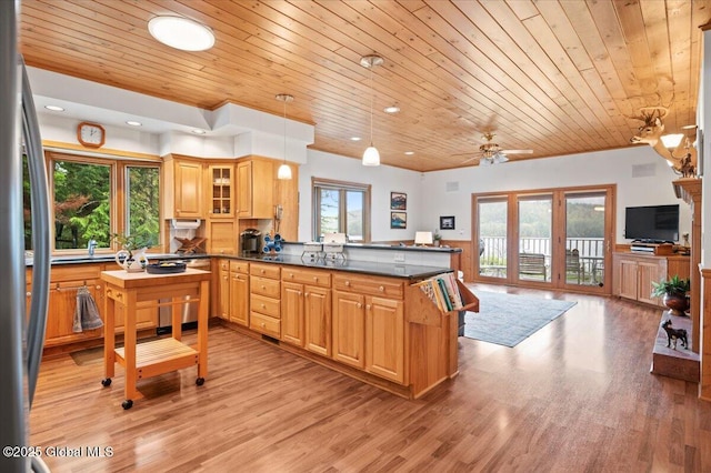 536 E Shore Dr, Horicon, NY 12808 - kitchen featuring wood ceiling, a peninsula, dark countertops, freestanding refrigerator, and light wood finished floors