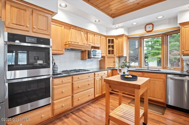 536 E Shore Dr, Horicon, NY 12808 - kitchen featuring stainless steel appliances, wood ceiling, a sink, dark countertops, and custom exhaust hood
