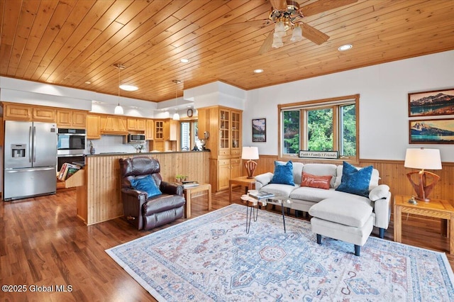 536 E Shore Dr, Horicon, NY 12808 - living area featuring wooden ceiling, a wainscoted wall, a ceiling fan, wooden walls, and wood finished floors