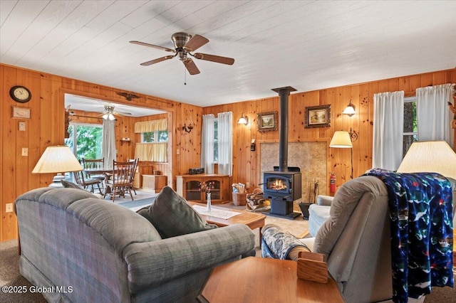 536 E Shore Dr, Horicon, NY 12808 - living area with a ceiling fan, wood walls, and a wood stove