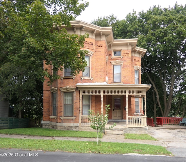 44 Cliff St, Canajoharie Village, NY 13317 - italianate-style house with covered porch, brick siding, and fence