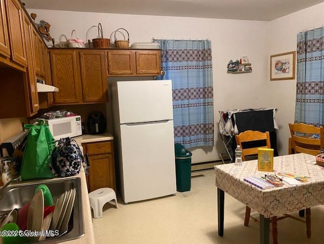 44 Cliff St, Canajoharie Village, NY 13317 - kitchen featuring light carpet, white appliances, brown cabinets, light countertops, and under cabinet range hood