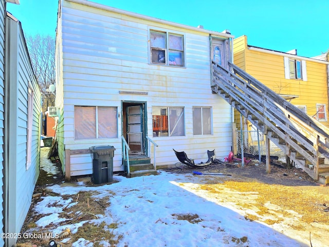 view of snow covered rear of property