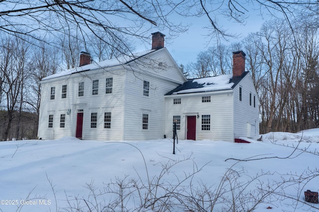 view of front of house featuring a garage and a chimney