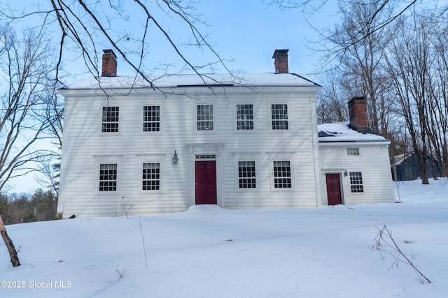 colonial inspired home featuring a chimney