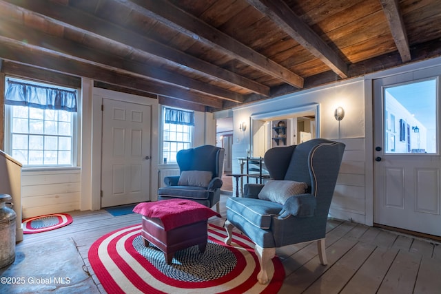 living area with hardwood / wood-style flooring, beamed ceiling, wood ceiling, and a healthy amount of sunlight