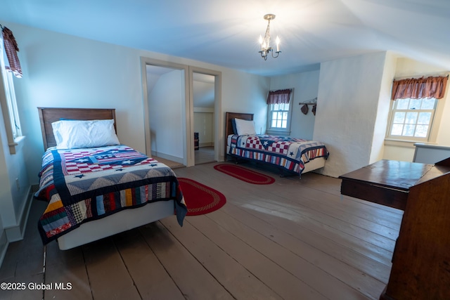 bedroom featuring an inviting chandelier and hardwood / wood-style flooring