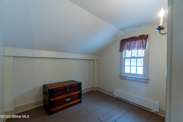 bonus room with vaulted ceiling, wood finished floors, baseboards, and baseboard heating