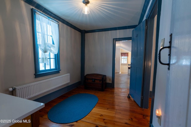 interior space with radiator and hardwood / wood-style floors