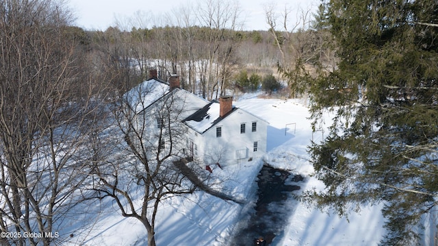 snowy aerial view with a forest view