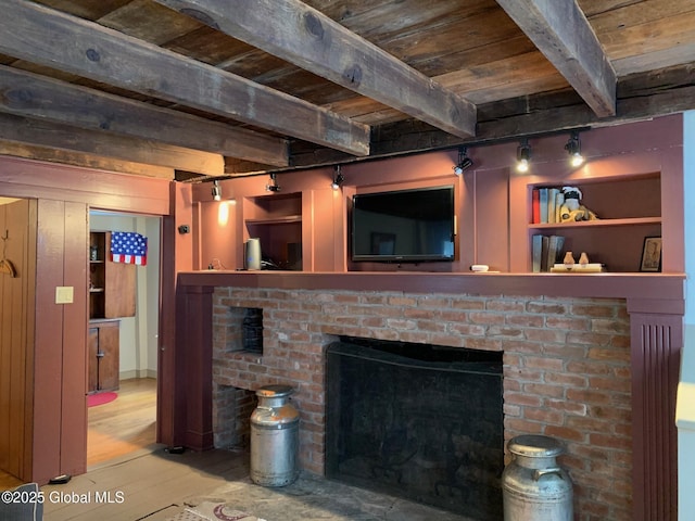 living room featuring beamed ceiling, a fireplace, wood ceiling, and wood finished floors