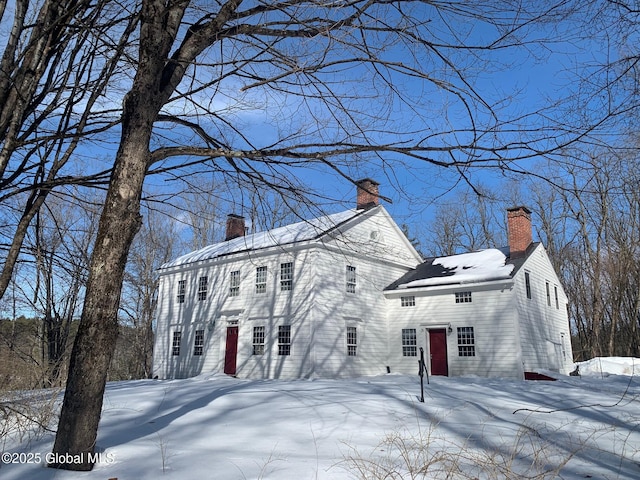 view of front of house featuring a chimney and entry steps