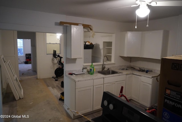 kitchen with ceiling fan, white cabinets, a sink, and light countertops