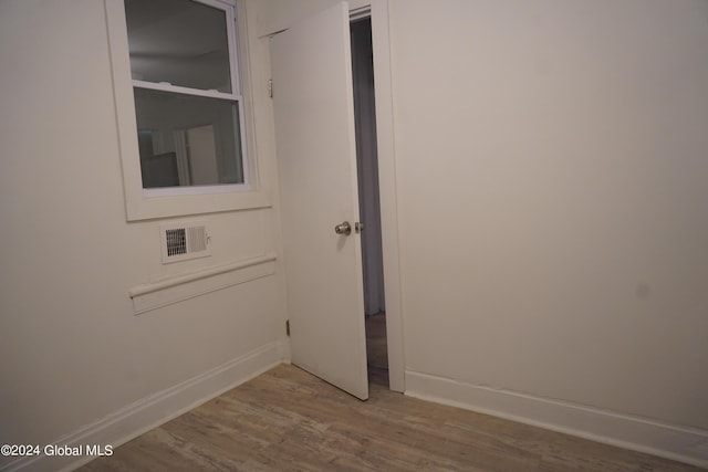 interior space featuring wood finished floors, visible vents, and baseboards