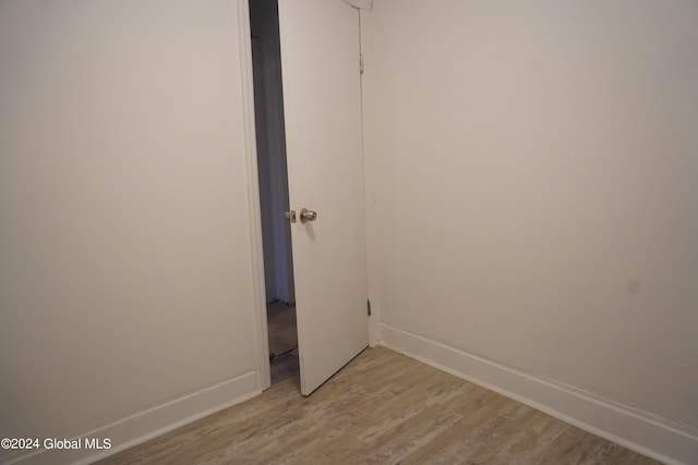 spare room with light wood-style flooring and baseboards