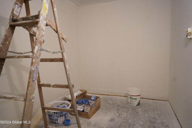 interior space featuring baseboards and wood finished floors