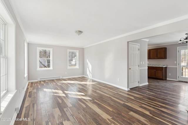 spare room featuring a baseboard heating unit, ornamental molding, dark wood finished floors, and baseboards