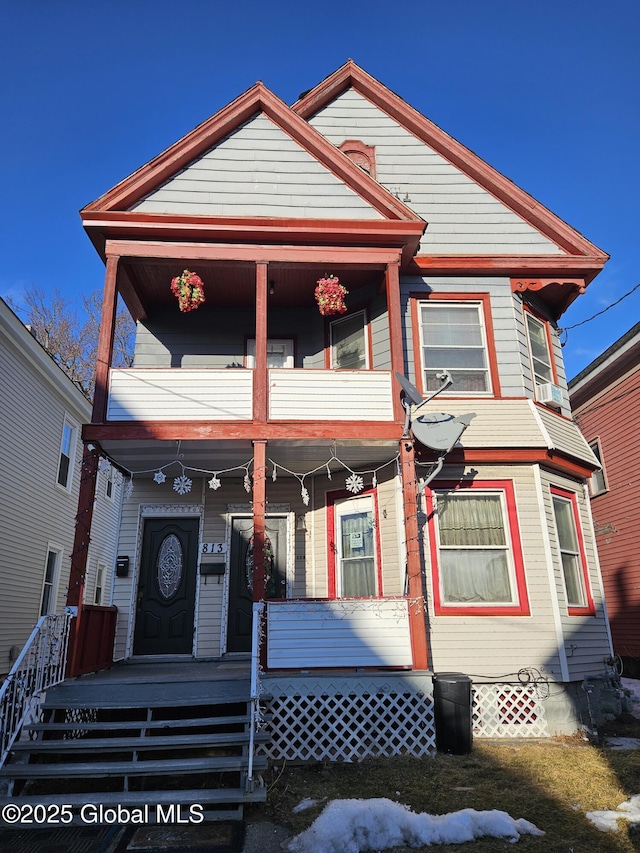 view of front facade with covered porch and a balcony