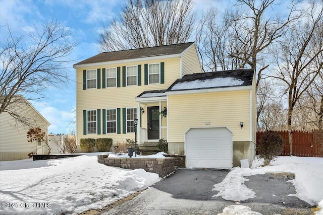 view of front facade with fence and driveway